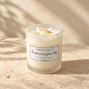 Sunshine and Good Vibes candle on pale stone